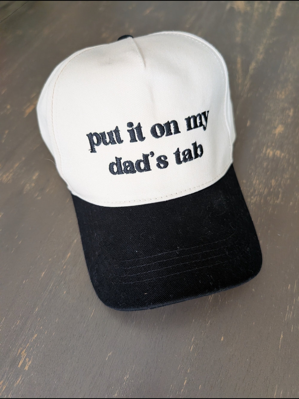 Altar’d State “Put It On My Dad’s Tab” trucker hat in ivory and black
